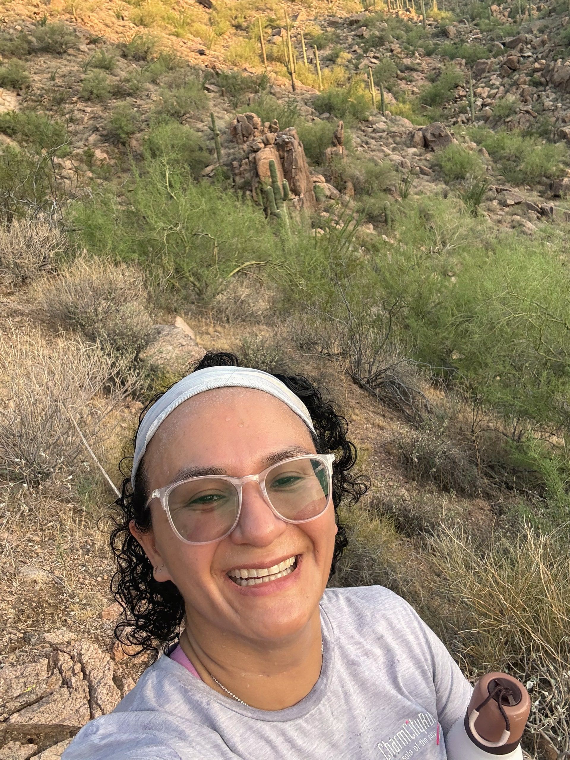 Viviana hiking among saguaro cactus in the desert