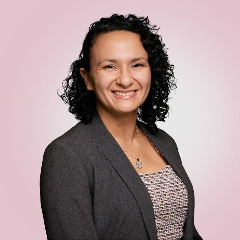 Viviana Acosta, smiling, in a charcoal blazer